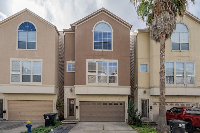 5817 Katy St, Houston, TX 77007 - traditional-style home with driveway, stucco siding, and a garage
