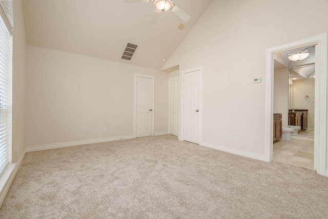 5817 Katy St, Houston, TX 77007 - unfurnished bedroom with light colored carpet, ensuite bathroom, high vaulted ceiling, and ceiling fan