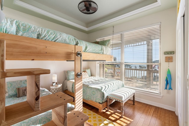 129 Lakeshore Dr, Onalaska, TX 77360 - bedroom with a tray ceiling, multiple windows, and wood-type flooring