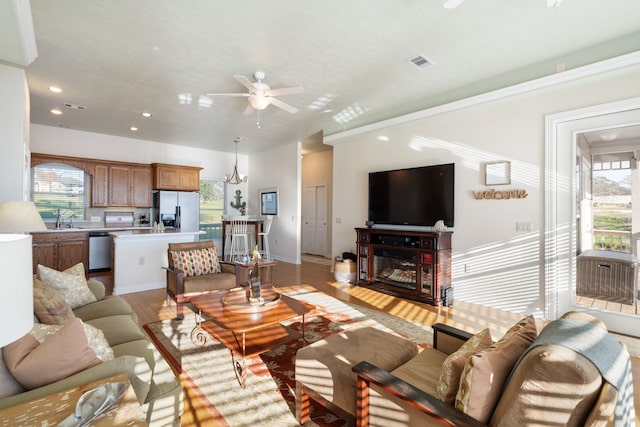 129 Lakeshore Dr, Onalaska, TX 77360 - living area featuring ceiling fan, healthy amount of natural light, light wood-type flooring, recessed lighting, and a glass covered fireplace