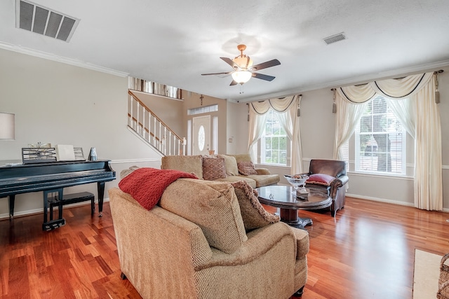 9706 Broadley Dr, Sugar Land, TX 77498 - living room featuring wood finished floors, ceiling fan, stairs, and ornamental molding