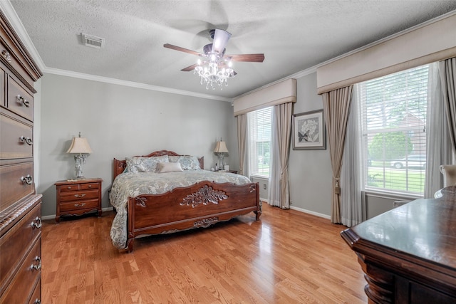 9706 Broadley Dr, Sugar Land, TX 77498 - bedroom with light wood finished floors, a textured ceiling, ornamental molding, and a ceiling fan