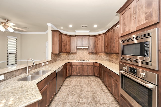 5627 Darling, Houston, TX 77007 - kitchen with stainless steel appliances, decorative backsplash, light stone counters, ceiling fan, and crown molding