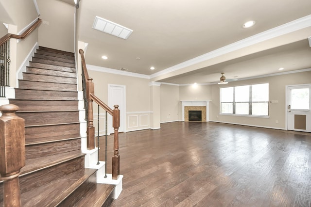 5627 Darling, Houston, TX 77007 - unfurnished living room with ceiling fan, crown molding, a glass covered fireplace, stairway, and dark wood-style floors
