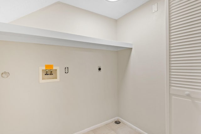 21315 Gulf Dr, Galveston, TX 77554 - washroom with washer hookup, hookup for an electric dryer, and light tile patterned floors