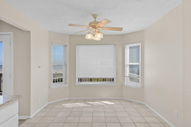 21315 Gulf Dr, Galveston, TX 77554 - spare room with ceiling fan, light tile patterned flooring, and a textured ceiling