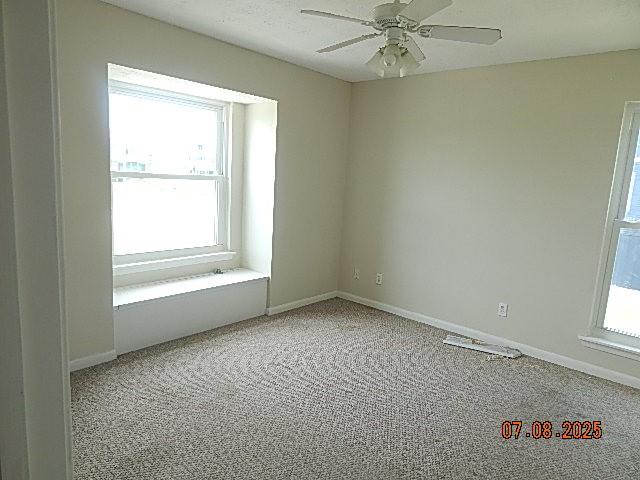 21315 Gulf Dr, Galveston, TX 77554 - spare room with carpet floors and ceiling fan