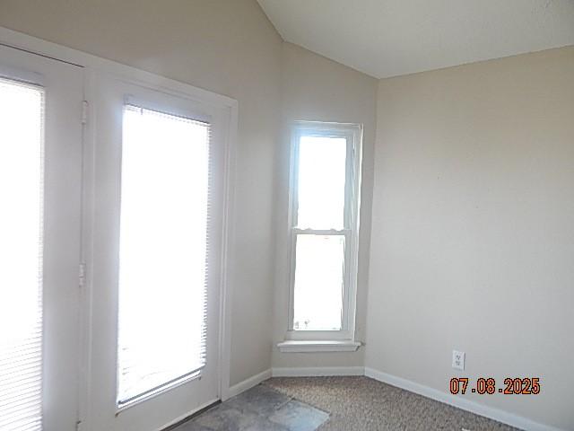 21315 Gulf Dr, Galveston, TX 77554 - empty room featuring carpet and vaulted ceiling