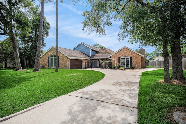 3014 Bayou Dr, La Porte, TX 77571 - view of front of property featuring brick siding, curved driveway, a chimney, and a garage