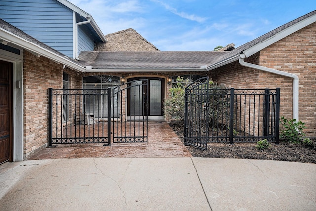 3014 Bayou Dr, La Porte, TX 77571 - entrance to property with brick siding, a gate, and roof with shingles