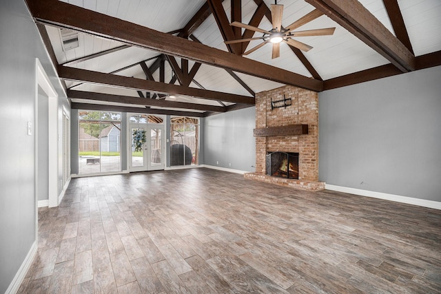 3014 Bayou Dr, La Porte, TX 77571 - unfurnished living room featuring ceiling fan, wood finished floors, and a brick fireplace