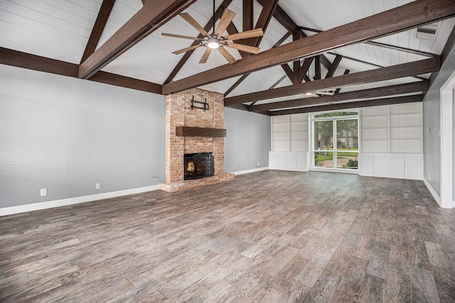 3014 Bayou Dr, La Porte, TX 77571 - unfurnished living room with wood finished floors, a fireplace, ceiling fan, beam ceiling, and high vaulted ceiling