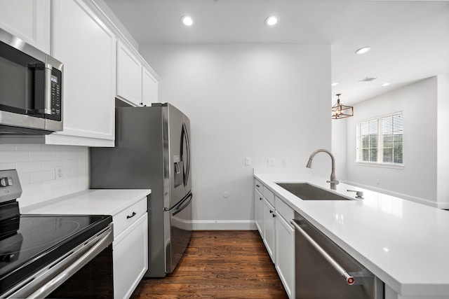 2924 Leeland St, Houston, TX 77003 - kitchen featuring appliances with stainless steel finishes, a peninsula, recessed lighting, tasteful backsplash, and dark wood-style floors