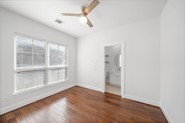 2924 Leeland St, Houston, TX 77003 - unfurnished bedroom with dark wood-style floors, ceiling fan, and ensuite bathroom