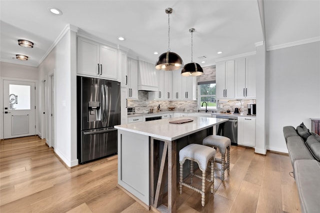 110 Penguin Pt, Point Blank, TX 77364 - kitchen featuring appliances with stainless steel finishes, ornamental molding, recessed lighting, backsplash, and light countertops