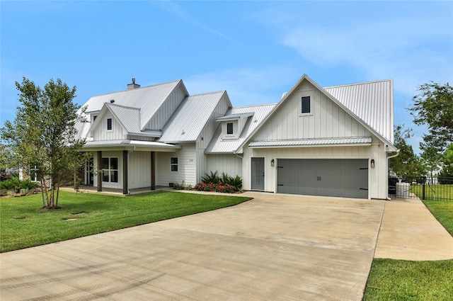 110 Penguin Pt, Point Blank, TX 77364 - modern farmhouse style home featuring driveway, board and batten siding, a metal roof, and a garage