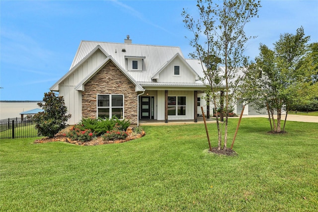 110 Penguin Pt, Point Blank, TX 77364 - modern inspired farmhouse with board and batten siding, stone siding, a metal roof, driveway, and a garage