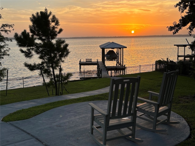 110 Penguin Pt, Point Blank, TX 77364 - patio terrace at dusk featuring a water view, a boat dock, and boat lift