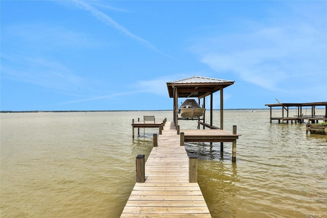 110 Penguin Pt, Point Blank, TX 77364 - dock featuring boat lift and a water view