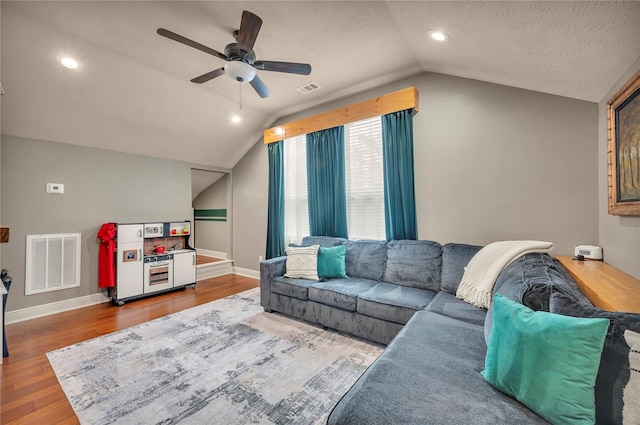 10252 Sunset Ln, Conroe, TX 77385 - living area with vaulted ceiling, wood finished floors, a ceiling fan, and a textured ceiling