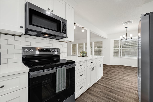 4005 Stoneybrook St, Baytown, TX 77521 - kitchen with appliances with stainless steel finishes, a chandelier, tasteful backsplash, white cabinets, and dark wood-style flooring