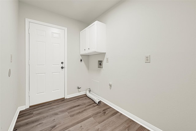 4005 Stoneybrook St, Baytown, TX 77521 - washroom featuring gas dryer hookup, light wood finished floors, washer hookup, electric dryer hookup, and cabinet space