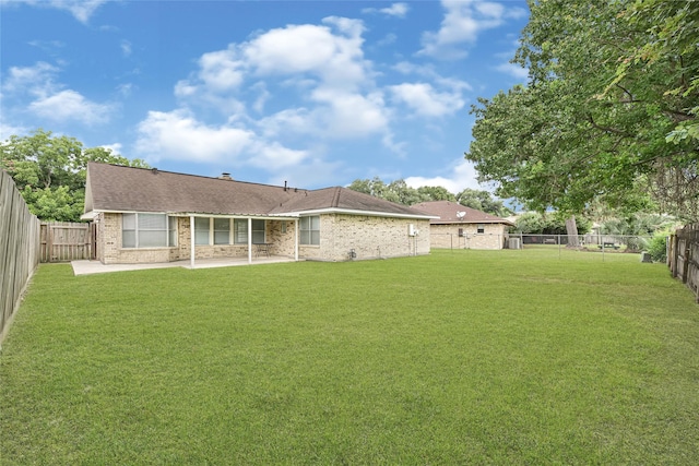 4005 Stoneybrook St, Baytown, TX 77521 - back of property with a patio area, brick siding, a fenced backyard, and a shingled roof
