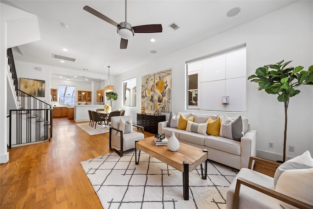 2310 Arabelle St, Houston, TX 77007 - living room with a ceiling fan, stairway, light wood finished floors, and recessed lighting