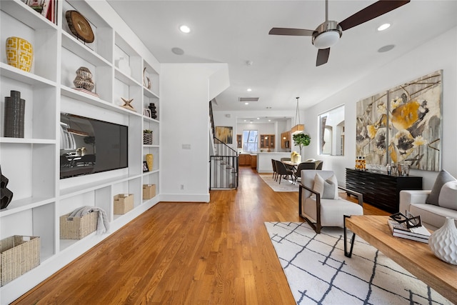 2310 Arabelle St, Houston, TX 77007 - living area featuring ceiling fan, light wood-type flooring, stairway, built in features, and recessed lighting