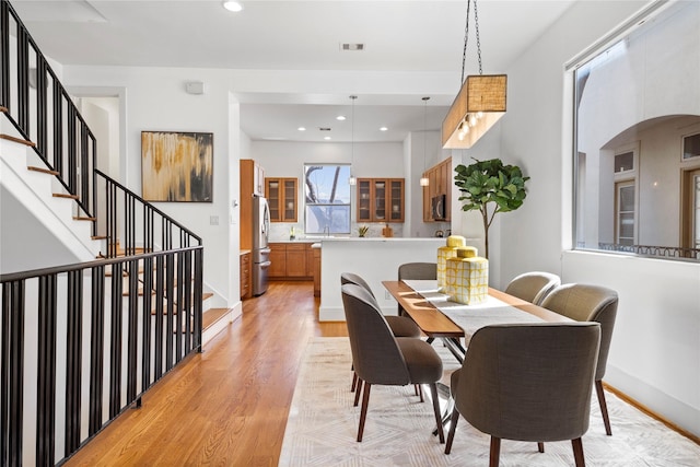 2310 Arabelle St, Houston, TX 77007 - dining space featuring light wood finished floors, stairs, and recessed lighting