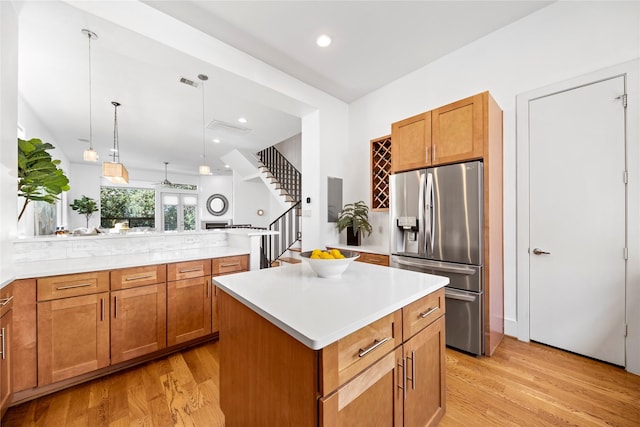 2310 Arabelle St, Houston, TX 77007 - kitchen featuring stainless steel refrigerator with ice dispenser, light wood-type flooring, brown cabinets, light countertops, and recessed lighting
