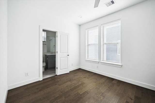 2212 Mcgowen St, Houston, TX 77004 - unfurnished bedroom featuring dark wood-style floors, ensuite bathroom, and ceiling fan