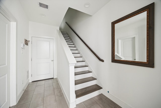 2212 Mcgowen St, Houston, TX 77004 - stairway with tile patterned flooring and baseboards