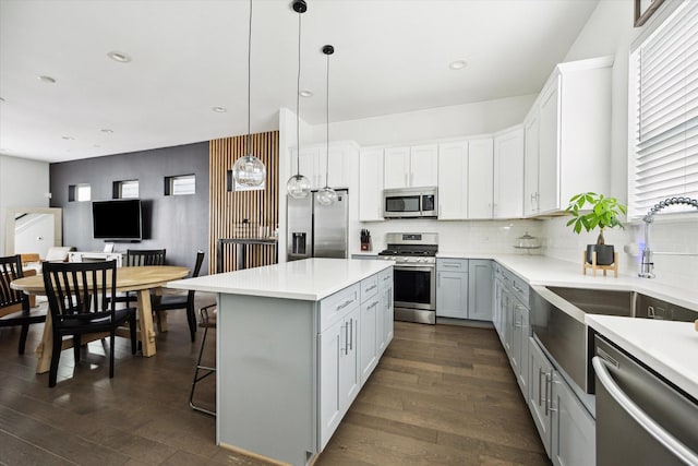2212 Mcgowen St, Houston, TX 77004 - kitchen featuring stainless steel appliances, dark wood-type flooring, light countertops, and recessed lighting