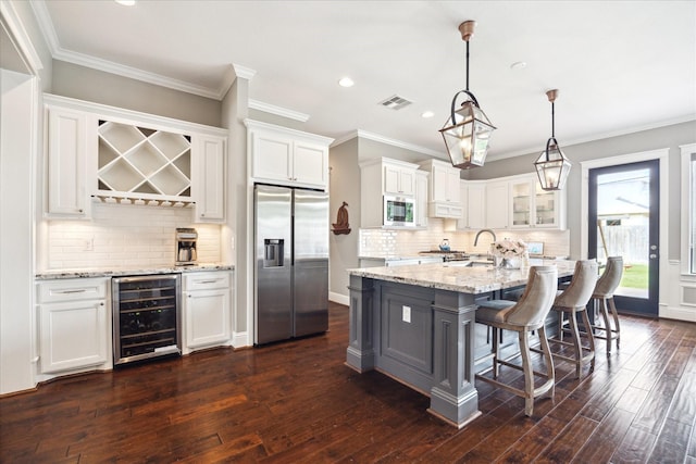 1346 Thornton Rd, Houston, TX 77018 - kitchen featuring stainless steel appliances, wine cooler, white cabinetry, recessed lighting, and dark wood-type flooring