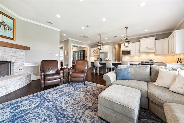 1346 Thornton Rd, Houston, TX 77018 - living room featuring dark wood-type flooring, recessed lighting, ornamental molding, and a brick fireplace