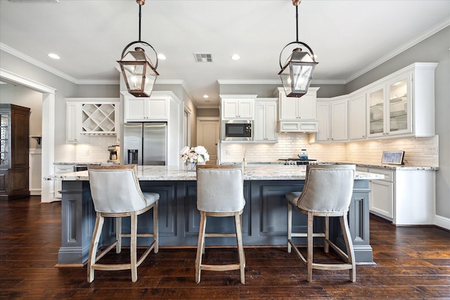 1346 Thornton Rd, Houston, TX 77018 - kitchen with appliances with stainless steel finishes, recessed lighting, white cabinets, a large island, and tasteful backsplash