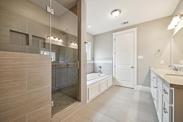1346 Thornton Rd, Houston, TX 77018 - bathroom featuring a garden tub, double vanity, and a stall shower