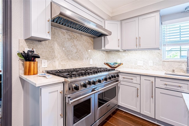 3217 Parkwood Dr, Houston, TX 77021 - kitchen with double oven range, ornamental molding, extractor fan, light countertops, and dark wood-type flooring