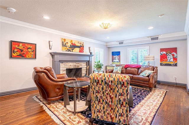 3217 Parkwood Dr, Houston, TX 77021 - living room with ornamental molding, wood finished floors, a textured ceiling, and a fireplace