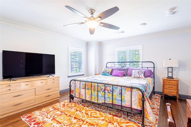 3217 Parkwood Dr, Houston, TX 77021 - bedroom with wood finished floors, multiple windows, ornamental molding, and a ceiling fan