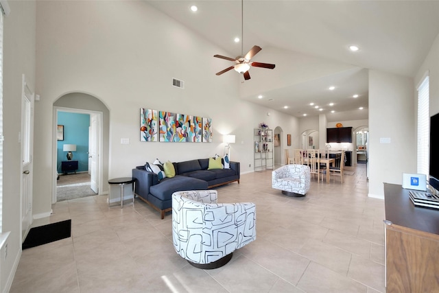 22223 Ebbets Field Dr, Spring, TX 77389 - living area with arched walkways, high vaulted ceiling, a ceiling fan, light tile patterned floors, and recessed lighting