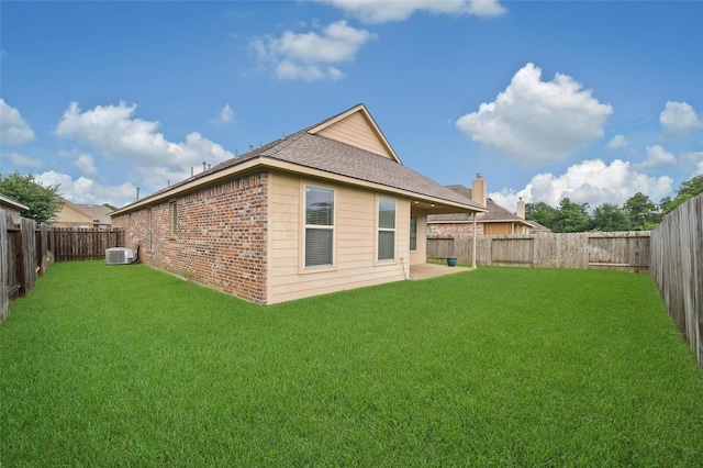 22223 Ebbets Field Dr, Spring, TX 77389 - back of house featuring brick siding, a fenced backyard, and roof with shingles