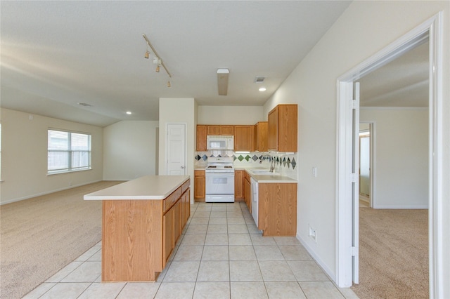 20218 Cypresswood Gln, Spring, TX 77373 - kitchen with white appliances, light countertops, light carpet, a kitchen island, and light tile patterned floors