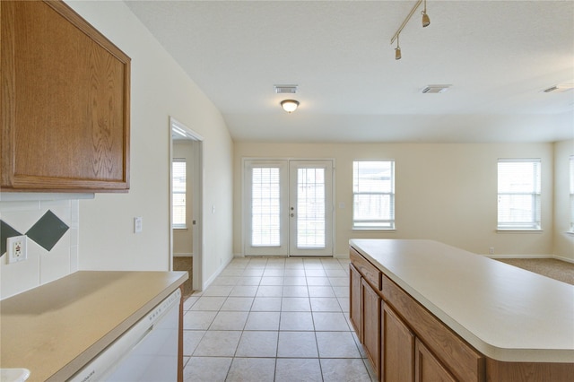 20218 Cypresswood Gln, Spring, TX 77373 - kitchen featuring french doors, dishwasher, brown cabinetry, and light countertops