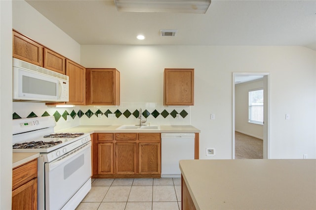 20218 Cypresswood Gln, Spring, TX 77373 - kitchen with white appliances, backsplash, light countertops, brown cabinets, and recessed lighting
