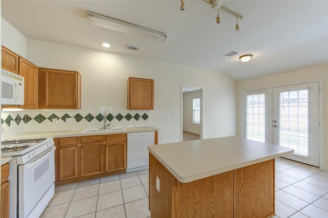 20218 Cypresswood Gln, Spring, TX 77373 - kitchen with white appliances, tasteful backsplash, light tile patterned floors, brown cabinetry, and vaulted ceiling