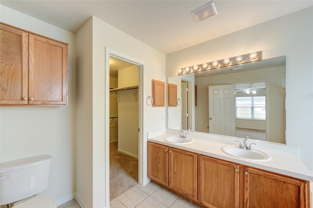 20218 Cypresswood Gln, Spring, TX 77373 - full bathroom with double vanity, tile patterned flooring, ceiling fan, and a walk in closet