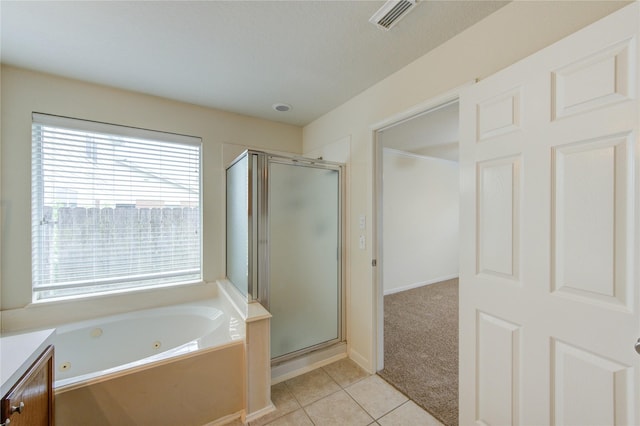 20218 Cypresswood Gln, Spring, TX 77373 - full bathroom featuring a shower stall, a jetted tub, tile patterned floors, and vanity