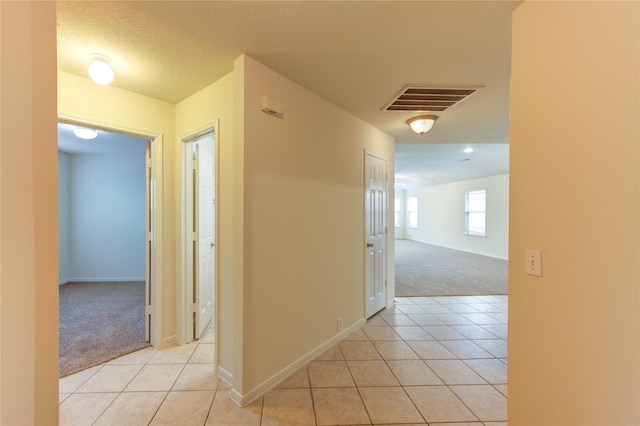 20218 Cypresswood Gln, Spring, TX 77373 - corridor with light carpet and light tile patterned floors